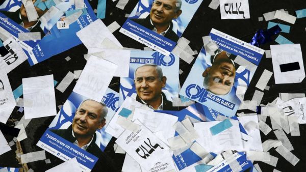 Israeli Likud Party campaign material and posters of Prime Minister Benjamin Netanyahu strown on the floor following election night at the party headquarters in the coastal city of Tel Aviv. (Jack GUEZ / AFP)