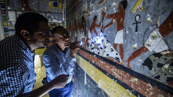 Mohamed Mujahid (L), head of the Egyptian mission which discovered the tomb of the ancient Egyptian nobleman "Khewi" dating back to the 5th dynasty (2494–2345 BC). (AFP)