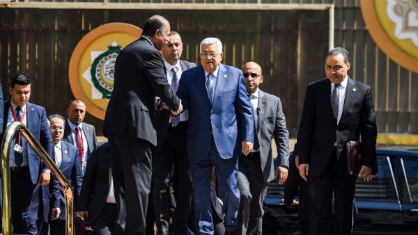 Palestinian president Mahmoud Abbas (C) is greeted upon his arrival at the Arab League headquarters in Cairo, on April 21, 2019. (MOHAMED EL-SHAHED / AFP) Palestinian president Mahmoud Abbas (C) is greeted upon his arrival at the Arab League headquarters in Cairo, on April 21, 2019. (MOHAMED EL-SHAHED / AFP)