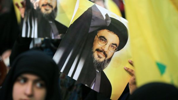 A Shiite supporter holds a poster showing Hassan Nasrallah, the head of Lebanon's militant Shiite Muslim movement Hezbollah. (AFP/ File)