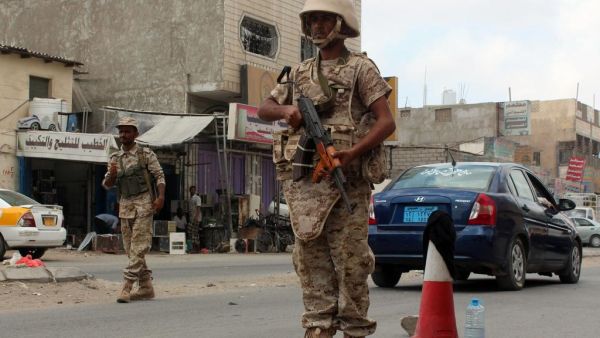 Loyalist forces stand guard on a main road in Al Mansoura district. (AFP/ File)