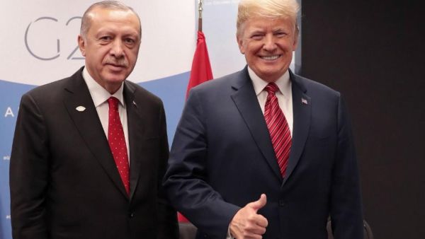 Turkey's President Recep Tayyip Erdogan, left, with US President Donald Trump at G20 summit in Buenos Aires, Argentina, on 1 December (AFP)