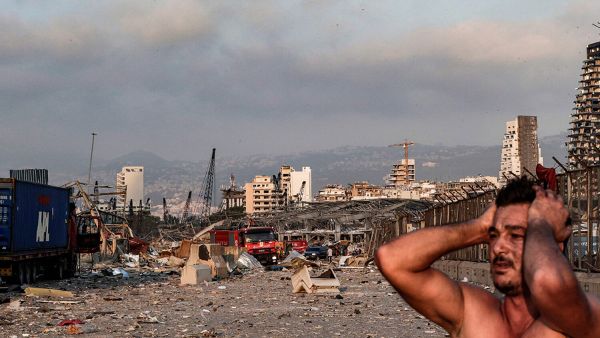 A man stands shocked after the August 4 blast in Beirut's port (AFP/FILE) banner image