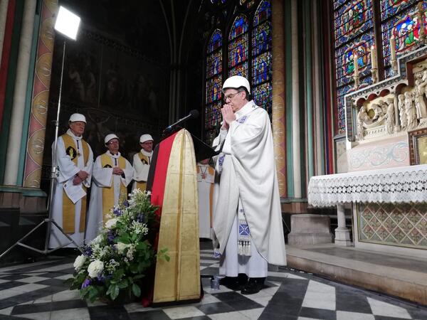 The Archbishop of Paris Michel Aupetit leads the first mass in a side chapel two months to the day after a devastating fire engulfed the Notre-Dame de Paris cathedral on June 15, 2019, in Paris. Karine PERRET / POOL / AFP