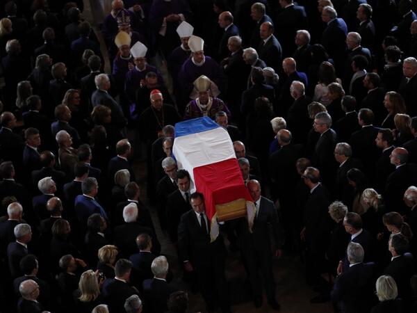 The coffin of the late French president Jacques Chirac is carried from the Saint Sulpice Church in the French capital Paris to a waiting hurst following his funeral service on September 30, 2019.  Francois Mori / POOL / AFP
