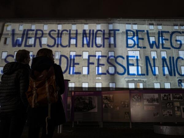 A giant banner reading: "He who does not move can not feel his restraints" is projected on the walls of the former Stasi (Former east German secret police) headquarters during the city-wide kick-off of the festival week to celebrate the 30th anniversary of the November 9,1989 fall of the Berlin Wall, in Berlin on November 4, 2019. Germany marks three decades since the fall of the Berlin Wall this week with main celebrations on November 9, 2019. John MACDOUGALL / AFP