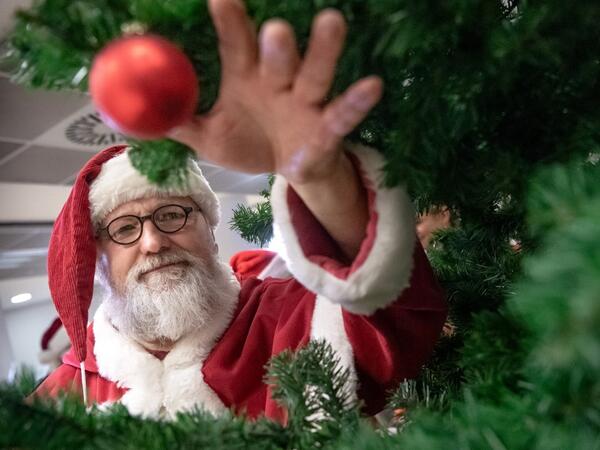 A man dressed as Santa Claus grabs a Christmas ball during an event on November 21, 2019 at the job center in Hanover, northern Germany, where informations were given on how to become a seasonal Christmas helper. Sina Schuldt / DPA / AFP