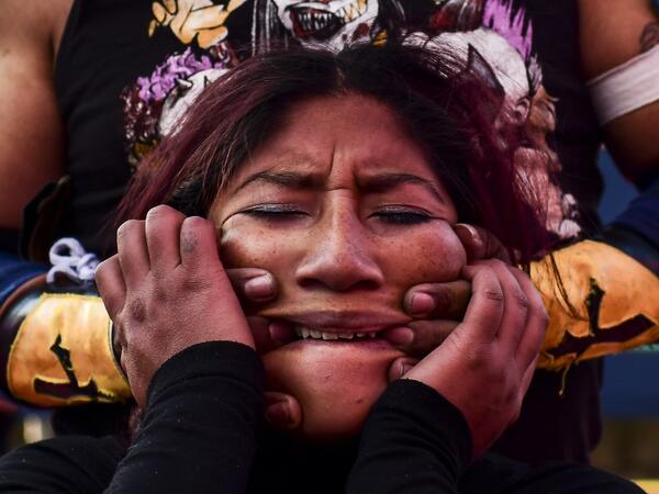 Bolivian wrestler Blanca Perez, aka "Katy The Beautiful", a member of the Fighting Cholitas, fights with a male wrestler at Sharks of the Ring wrestling club in El Alto, Bolivia, on November 24, 2019. After a fortnight hiatus due to anti-government protests and blockades, the Fighting Cholitas are back in the ring. The unrest was triggered by the disputed October 20 election, which Evo Morales claimed to have won and opposition groups said was rigged. Ronaldo SCHEMIDT / AFP