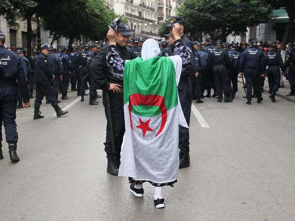 Algerian protesters face security forces during an anti-government demonstration in the capital Algiers on December 12, 2019 during the presidential election. STRINGER / AFP