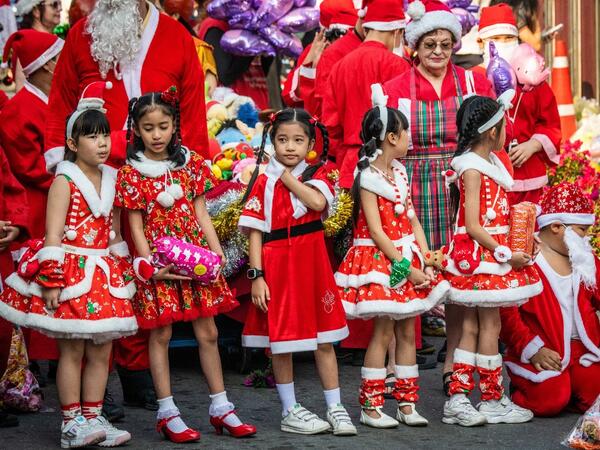 Children in Christmas costumes wait to receive gifts from elephants dressed in Santa Claus costumes during Christmas celebrations in Ayutthaya on December 23, 2019. Wearing red and white hats and a string of bells, Thai elephants passed out Christmas gifts to hundreds of schoolchildren on Monday despite growing criticism over using the animals in performances. The annual festive event is organised by a nearby elephant park, whose mahouts or handlers started in the early morning dressing the animals. Thailan