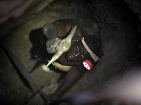 A gold miner works underground in Anka near Gusau, on December 4,2019. For generations, the mineral-rich earth of Nigeria's Zamfara state has provided families living here with a way to make ends meet. But in recent years their trade has become increasingly unsafe. The mines lie within the reach of heavily-armed groups -- dubbed "bandits" by the local authorities -- that have been terrorising this remote region.  Kola Sulaimon / AFP
