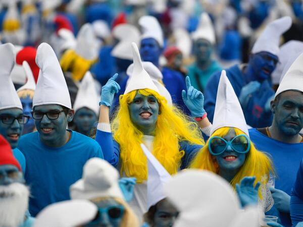 People dressed as Smurfs ('Schtroumpfs' in French), a Belgian comic franchise centered on a fictional colony of small, blue, human-like creatures who live in mushroom-shaped houses in the forest, attend a world record gathering of Smurfs on March 7, 2020, in Landerneau, western France. Damien MEYER / AFP