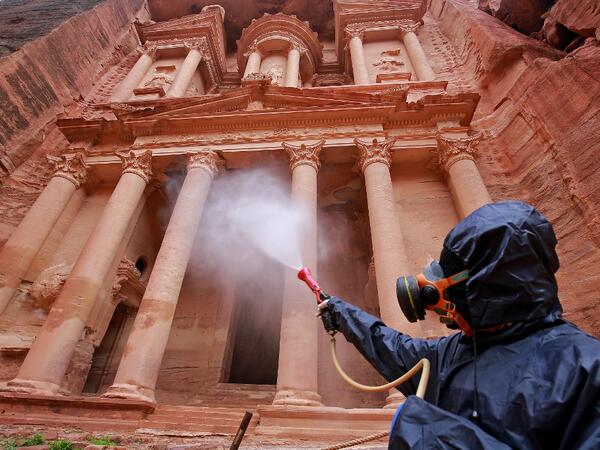 A labourer sprays disinfectant in Jordan's archaeological city of Petra south of the capital Amman on March 17, 2020, to prevent the spread of COVID-19. Khalil MAZRAAWI / afp