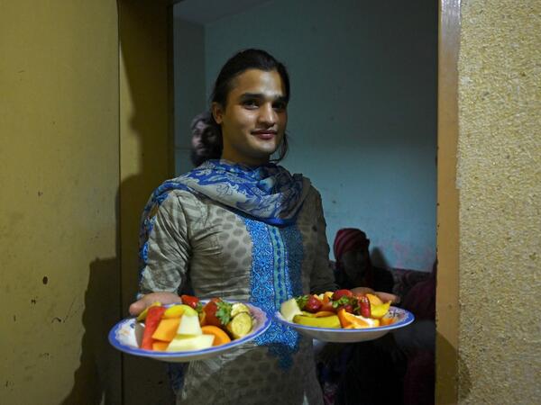 In this picture taken on May 9, 2020, a member of the transgender community carries food for "iftar" before breaking their fast during the Islamic holy month of Ramadan at the Guru transgender house in Rawalpindi. Transgender people in the country are known as "khawajasiras" or "hijras" -- an umbrella term denoting a third sex that includes transgender women and cross-dressers. Pakistan became one of the first countries in the world to legally recognise a third sex in 2009 and began issuing transgender pass