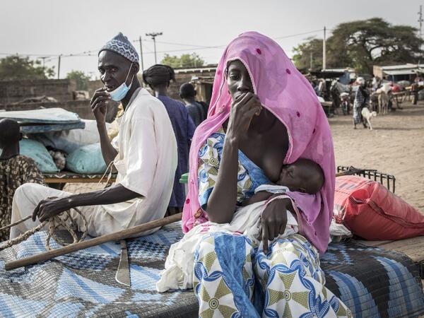 Fulani herders make their way back to their camps after trying to buy and sell goods at a unofficial herders market in Barkedji on May 28, 2020. COVID-19 coronavirus restrictions have closed down markets and regional movement, as a result Fulani herders are struggling to move to areas with more grazing land for there live stock. Closures of markets have meant that the prices for live stock has dropped by up to fifty percent, leaving the pastoralist stuck with out being able to pay for the provisions to move