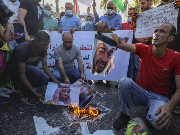 Palestinian protesters burn pictures of Abu Dhabi Crown Prince Sheikh Mohammed bin Zayed Al Nahyan (top) and Saudi Crown Prince Mohammed bin Salman, during a demonstration against the Emirati-Israeli agreement, in Ramallah in the occupied West Bank, on August 15, 2020. ABBAS MOMANI / AFP