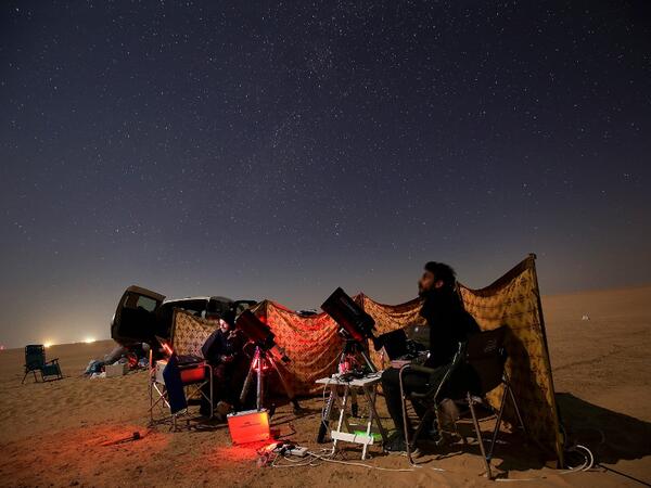 Kuwaiti astrophotographers follow the great conjunction between Jupiter and Saturn in al-Salmi district, a desert area 120 kms west of Kuwait City, on December 21, 2020. The great conjunction refers to the alignment of Jupiter and Saturn. YASSER AL-ZAYYAT / AFP