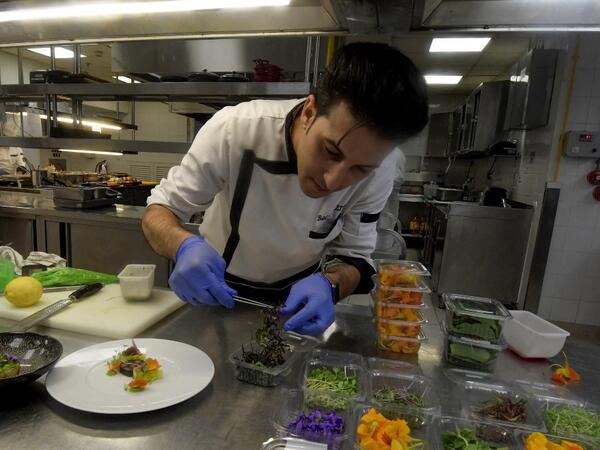 Tunisian chef Bassem Bizid uses edible flowers to prepare his dishes at a luxury hotel in Gammarth, an upscale northern suburb of the capital Tunis, on February 5, 2021. FETHI BELAID / AFP