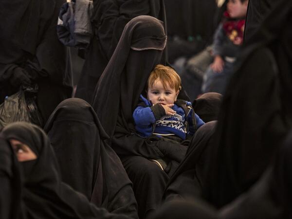 Syrians wait to leave the Kurdish-run al-Hol camp, which holds relatives of alleged Islamic State (IS) group fighters, in the Syrian northeastern al-Hasakeh governorate.