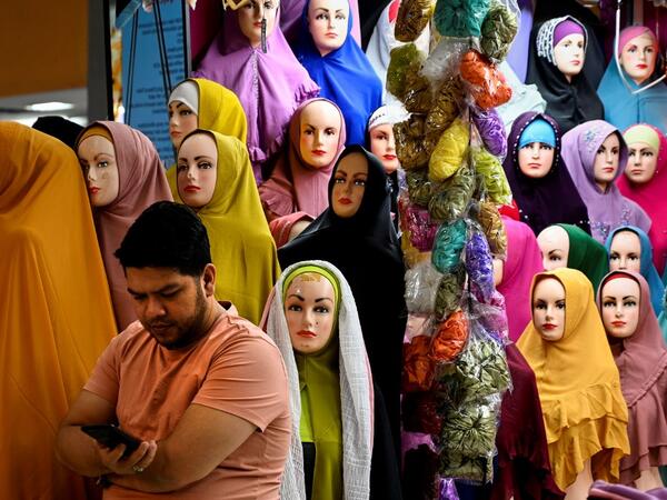A vendor waits for customers at a shopping centre ahead of Eid al-Adha celebrations in Banda Aceh on July 17, 2021. CHAIDEER MAHYUDDIN / AFP