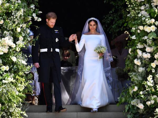Britain's Prince Harry, Duke of Sussex and his wife Meghan, Duchess of Sussex walk down the west steps of St George's Chapel, Windsor Castle, in Windsor, on May 19, 2018 after their wedding ceremony. 
Ben STANSALL/ AFP