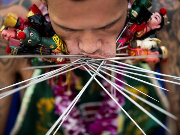 A devotee of the Loem Hu Thai Su shrine has multiple skewers pierced through his cheeks during the annual Vegetarian Festival in Phuket on October 12, 2018. Jewel SAMAD/AFP