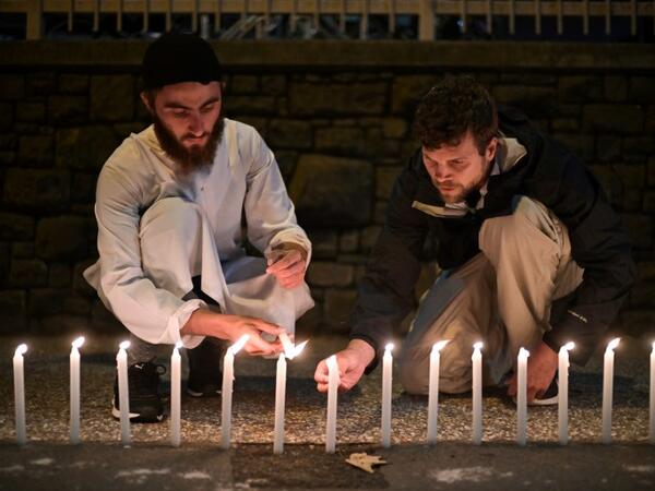 Well-wishers light 49 candles as they pay respects to victims outside the hospital in Christchurch 
Anthony WALLACE / AFP