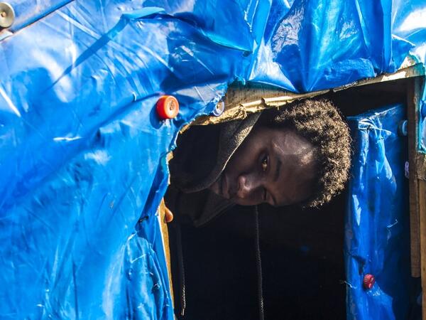 A sub-Saharan migrant comes out of a make-shift tent at the Oulad Ziane migrant camp in Casablanca on March 27, 2019. 
FADEL SENNA / AFP