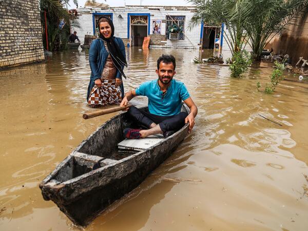 An Iranian man sits in a boat at his flooded garden in a village around the city of Ahvaz, in Iran's Khuzestan province. 
Mehdi PEDRAMKHOO / TASNIM NEWS / AFP