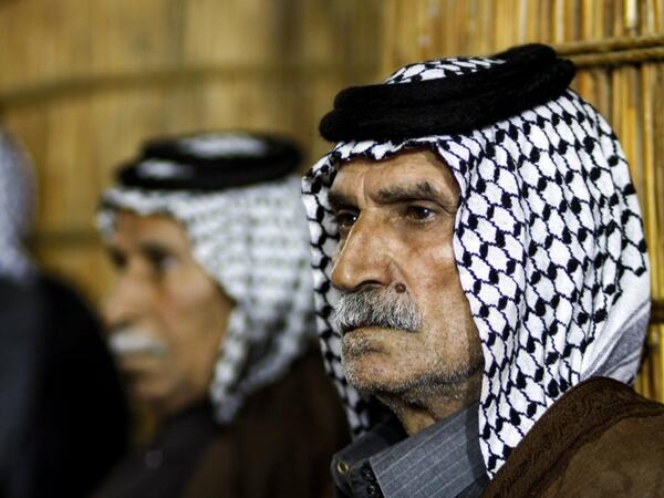 Members of an Iraqi clan gather inside a straw tent in the town of Mishkhab, south of Najaf on November 15, 2018. 
Haidar HAMDANI / AFP