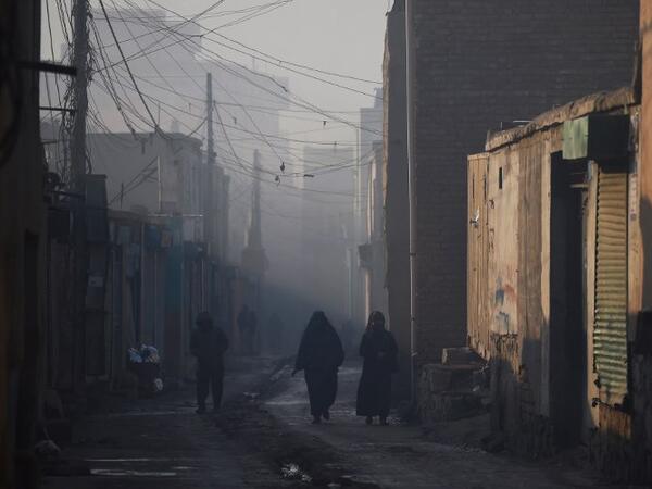 In this photograph Afghan residents walk along a street amid heavy smog conditions in the old quarters of Kabul. 
WAKIL KOHSAR / AFP