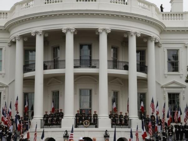 French President Emmanuel Macron (2nd R), US President Donald Trump (R), First Lady Melania Trump (2nd L) and Brigitte Macron listen to the national anthems during a state welcome at the White House in Washington, DC, on April 24, 2018. Ludovic MARIN / AFP