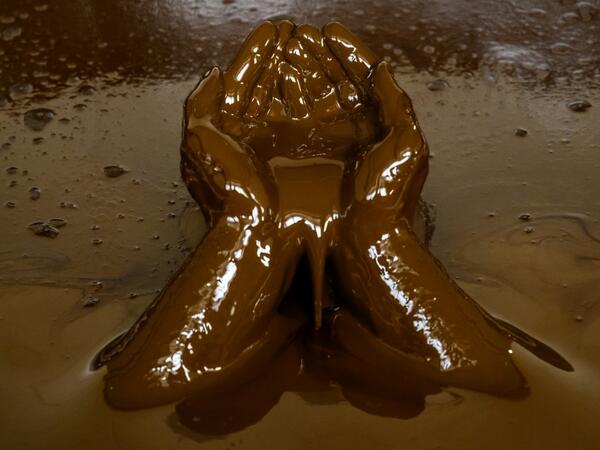 A man bathes in a tub filled with Naftalan crude oil during a treatment session at Sehirli Naftalan Health Center, some 300 kilometres (186 miles) from capital Baku, on March 21, 2019. Immersed up to her neck in crude oil, a Russian woman suffering from joint disease smiles in delight, confident that the treatment at a spa in northwestern Azerbaijan will cure her painful condition.  Mladen ANTONOV / AFP