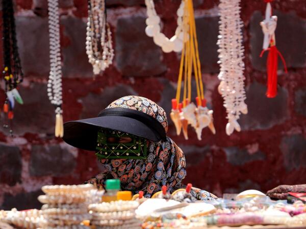 A woman sells souvenirs on the Hormuz Island in the Gulf Strait of Hormuz, off the Iranian port city of Bandar Abbas, on April 29, 2019.  ATTA KENARE / AFP