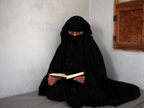 Hasna Dbeis, a 30-year-old former detainee in a Syrian-regime jail, reads a book at her home in the town of Maarat Nasrin in the rebel-held part of the Syrian Idlib province  Aaref WATAD / AFP
