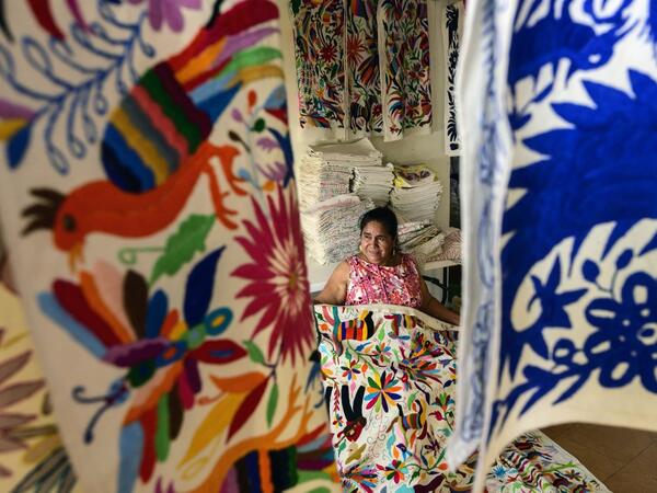 Mexican artisan Glafira Candelaria Jose, of the Otomi ethnic group, shows one of her designs at her workshop in San Nicolas village, in Tenango de Doria, Hidalgo state, Mexico.  Pedro PARDO / AFP