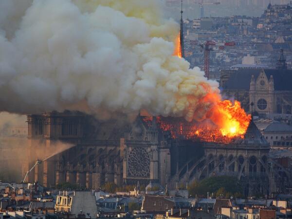 Smoke and flames rise during a fire at the landmark Notre-Dame Cathedral in central Paris on April 15, 2019, potentially involving renovation works being carried out at the site, the fire service said.  Hubert Hitier / AFP