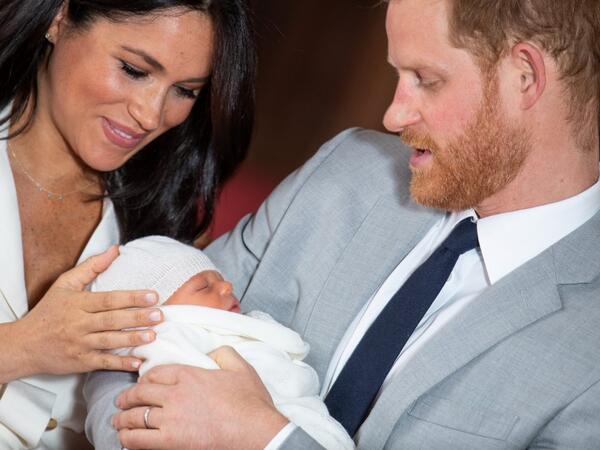 Britain's Prince Harry, Duke of Sussex (R), and his wife Meghan, Duchess of Sussex, pose for a photo with their newborn baby son, Archie Harrison Mountbatten-Windsor, in St George's Hall at Windsor Castle in Windsor, west of London on May 8, 2019.  Dominic Lipinski / POOL / AFP