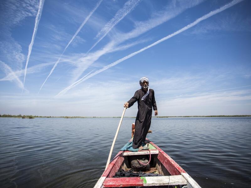 Abu Hayder, an Iraqi ecotourism guide, navigates a canoe in the marshes of the southern district of Chibayish in Dhi Qar province, about 120 kilometres northwest of the southern city of Basra, on March 29, 2019. Hussein FALEH / AFP