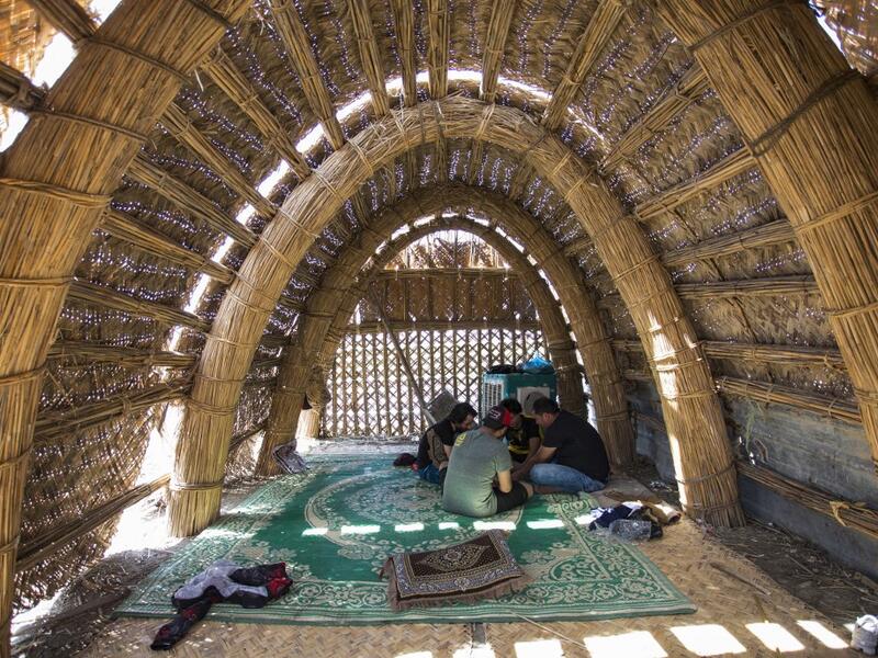 Tourists sitting inside a floating palm reed-woven house in the marshes of the southern Iraqi district of Chibayish in Dhi Qar province, about 120 kilometres northwest of the southern city of Basra. Hussein FALEH / AFP