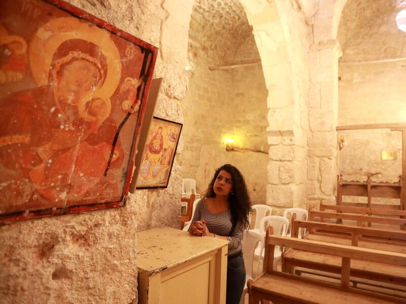 Rita Wahba recites hymns in Aramaic, at the Saint Sarkis monastery in the Syrian mountain village of Maalula, in the Damascus region on May 13, 2019. LOUAI BESHARA / AFP
