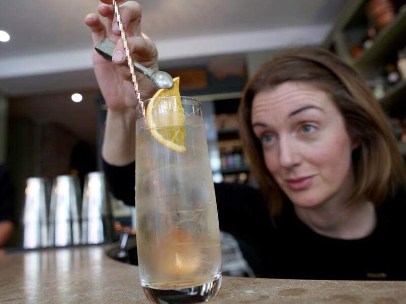 Head bartender Anna Walsh mixes a cocktail at the Virgin Mary pub, which opened recently selling non-alcoholic drinks and is known as the 'pub with no beer', in the city centre of Dublin on May 16, 2019. PAUL FAITH / AFP