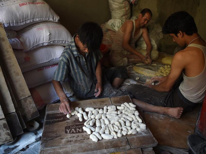 An Afghan worker prepares khajor, a local cooky made from flour and sugar, ahead of the Eid al-Fitr festival, which marks the end of Islamic holy month of Ramadan at a traditional sweets factory in Kabul on June 2, 2019. WAKIL KOHSAR / AFP