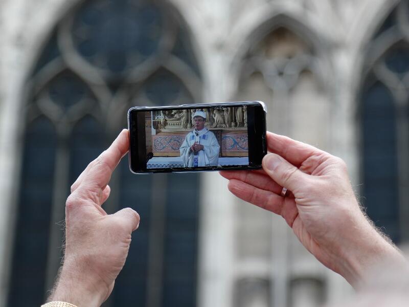 For safety reasons, the mass led by Archbishop of Paris Michel Aupetit will be celebrated on a very small scale. Worshippers will be expected to don hard hats but priests will be wearing their ceremonial garb. Zakaria ABDELKAFI / AFP