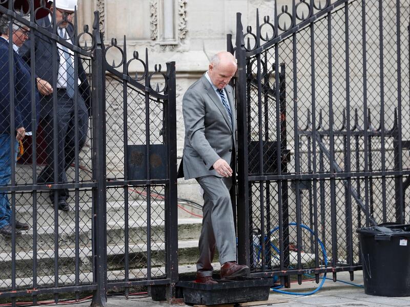 French Army General Jean-Louis Georgelin, in charge of Notre-Dame Cathedral's reconstruction (R) leaves after taking part in the first mass of cathedral on June 15, 2019, in Paris, two months after the April 15 devastating fire. Zakaria ABDELKAFI / AFP