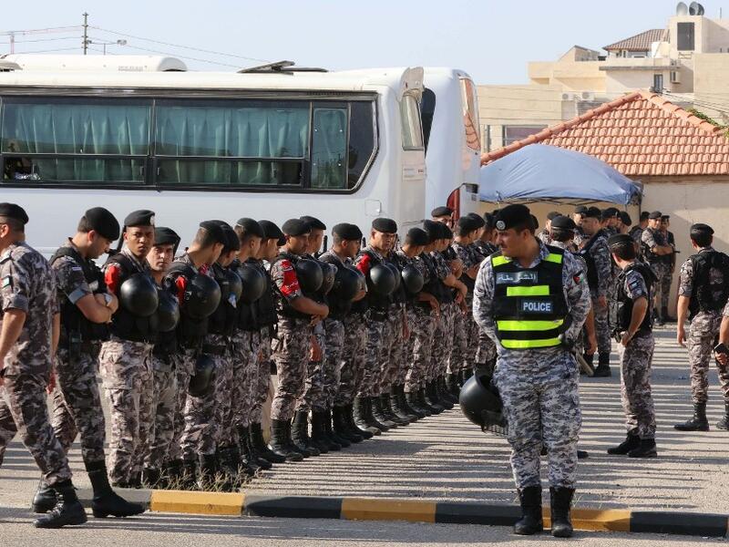 Members of the Jordanian Security forces stand guard outside the US embassy  during the "March of Anger" in the capital Amman on June 21, 2019, against  US President Donald Trump's "Deal of the Century" and the US-led Middle East economic conference in Bahrain.  Khalil MAZRAAWI / AFP