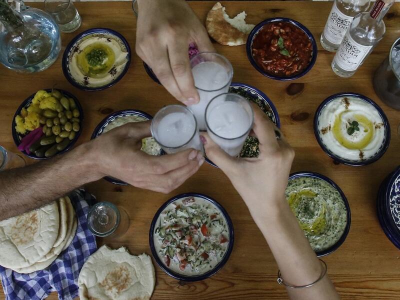 Palestinian distiller Nader Muaddi drinks his handcrafted Arak in the occupied West Bank city of Beit Jala, near Bethlehem, on June 16, 2019. In his basement, distiller Muaddi made fewer than 500 bottles of liquor last year, but it is earning global acclaim and reviving interest in the Palestinian alcohol sector. On the outskirts of the city famed for Jesus's birth, the 35-year-old illustrates the handcrafted way he makes Arak, an anise-flavoured drink popular in the Middle East and similar to Greek Ouzo, F