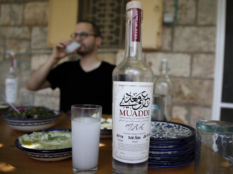 Palestinian distiller Nader Muaddi drinks his handcrafted Arak in the occupied West Bank city of Beit Jala, near Bethlehem, on June 16, 2019. In his basement, distiller Muaddi made fewer than 500 bottles of liquor last year, but it is earning global acclaim and reviving interest in the Palestinian alcohol sector. On the outskirts of the city famed for Jesus's birth, the 35-year-old illustrates the handcrafted way he makes Arak, an anise-flavoured drink popular in the Middle East and similar to Greek Ouzo, F