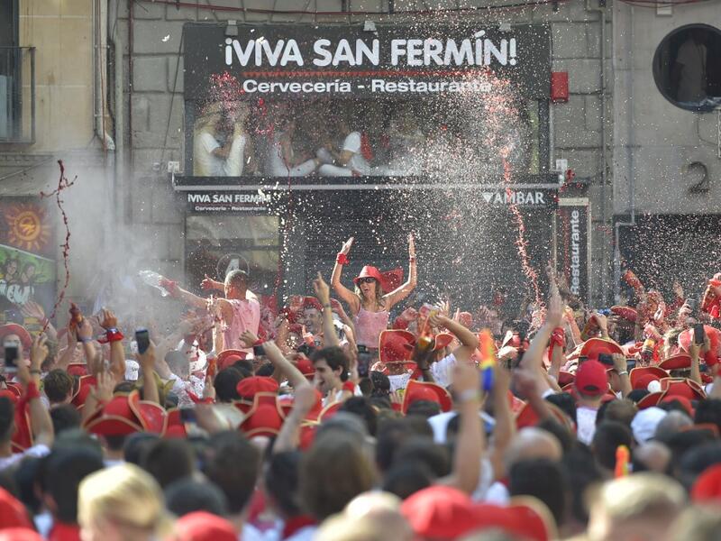 Revellers wait for the 'Chupinazo' (start rocket) to mark the kickoff at noon sharp of the San Fermin Festival, in front of the Town Hall of Pamplona, northern Spain, on July 6, 2019.  ANDER GILLENEA / AFP