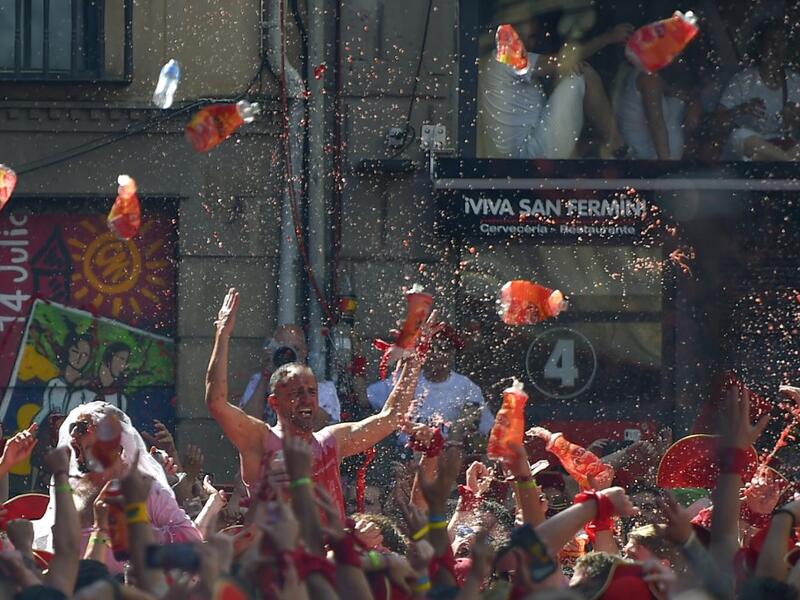 Revellers celebrate during the 'Chupinazo' (start rocket) to mark the kickoff at noon sharp of the San Fermin Festival, in front of the Town Hall of Pamplona, northern Spain, on July 6, 2019.  PIERRE-PHILIPPE MARCOU / AFP